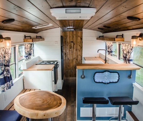 PTP School Bus Conversion - The dog house is one of the nicest tiny homes I've ever seen, with white cladded walls and lots of natural chunks of wood everywhere