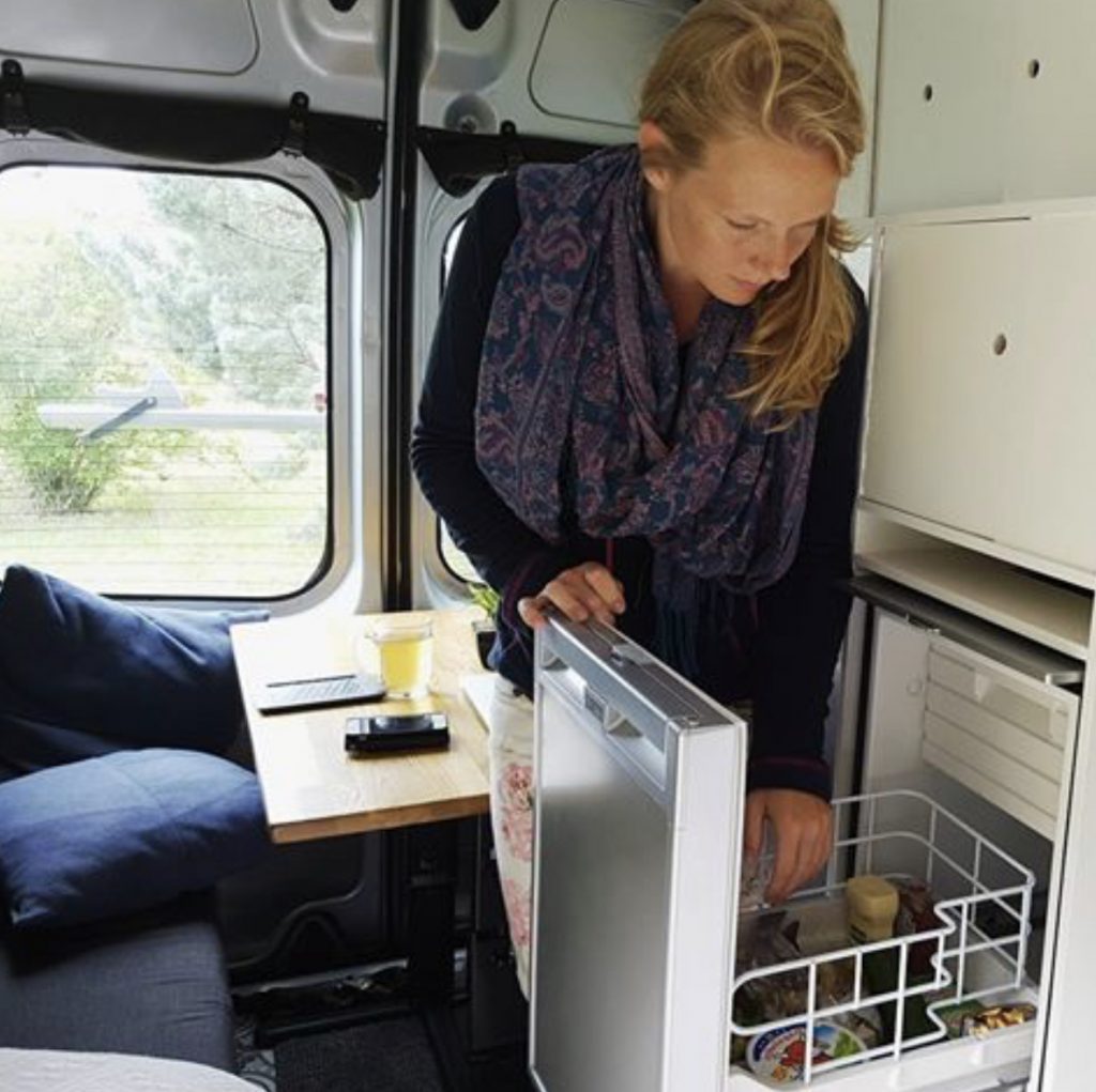 best campervan fridges - woman opening fridge 