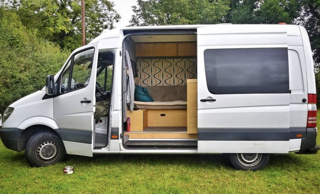 Stealth campers - van with side door open showing glimpse of interior. 