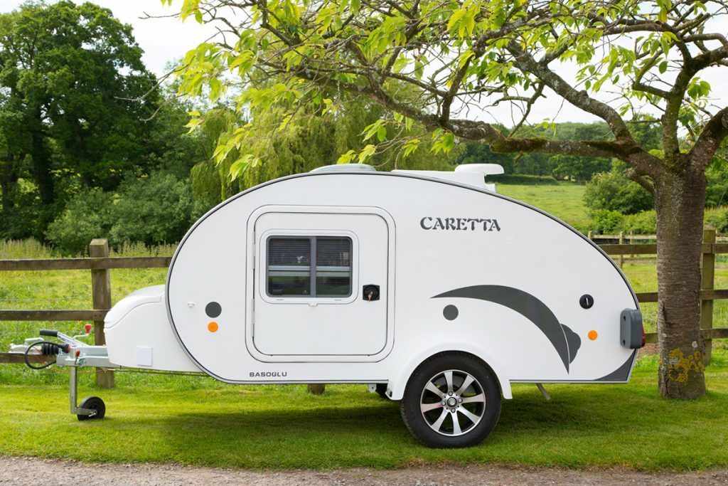 White Caretta Teardrop trailer by a field