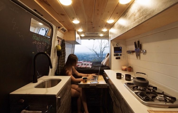 Camper life- woman working inside van 