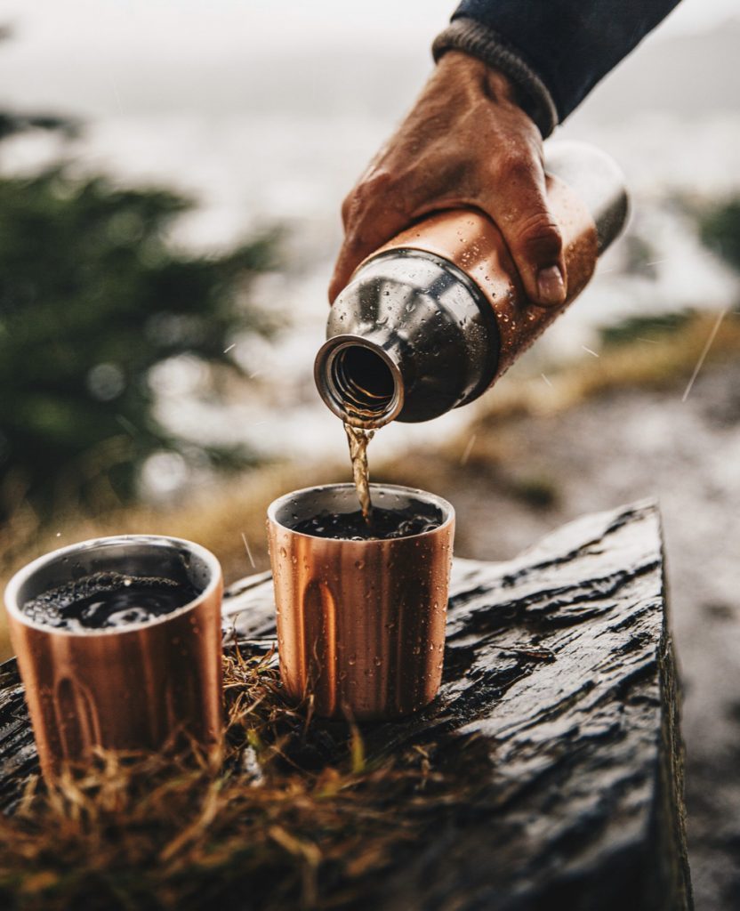 Pouring a dink into tumblers from the High Camp Flask 