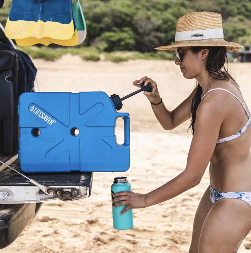 Woman using Lifesaver jerry can on beach 