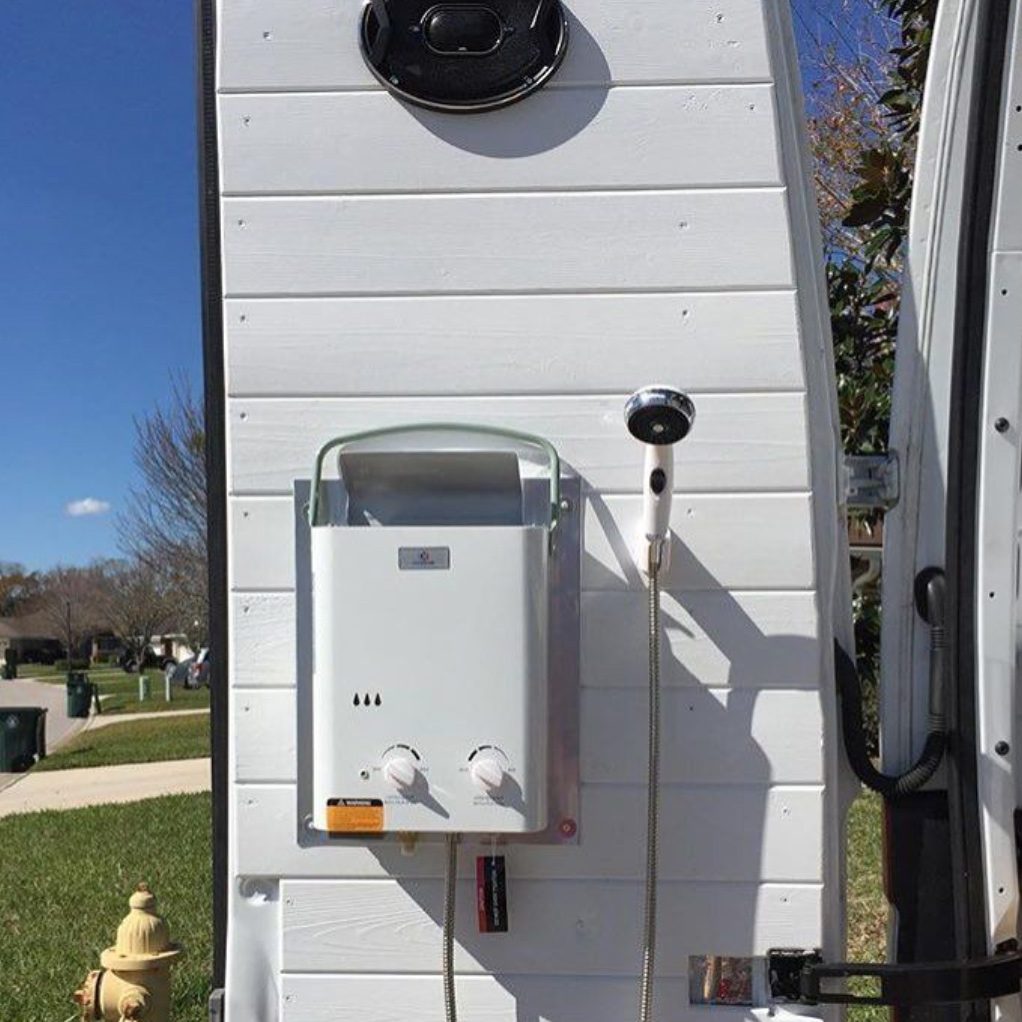 Eccotemp L5 tankless water heater installed on the back door of a camper van