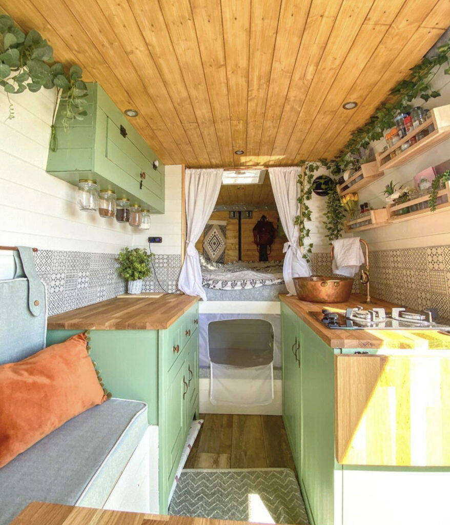 Conversion Vans - van interior with fixed bed, kitchen and seating  