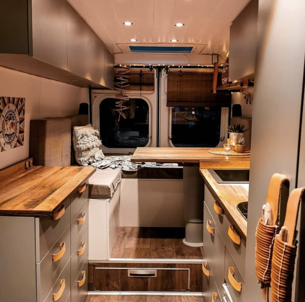 Conversion Vans - Seating area that converts to bed at back, kitchen at front in dark grey 