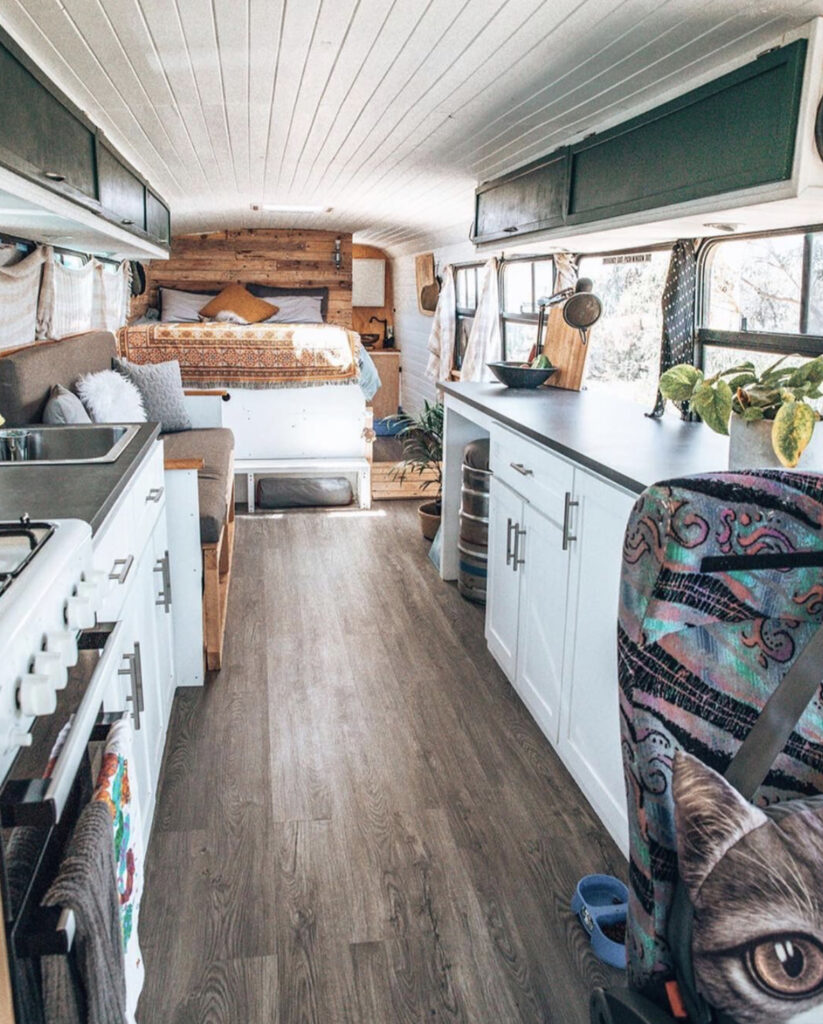 Open plan bus conversion with kitchen sofa and bed 